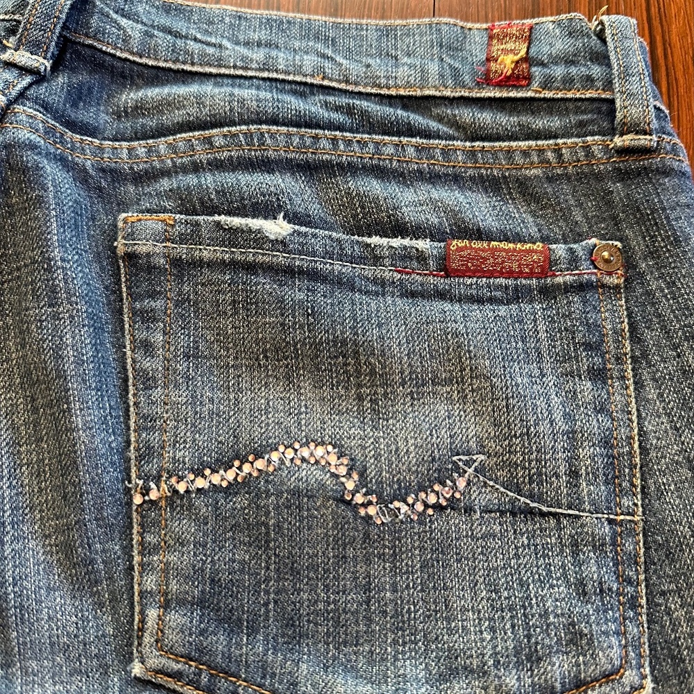Swarovski crystal, bootcut jeans.